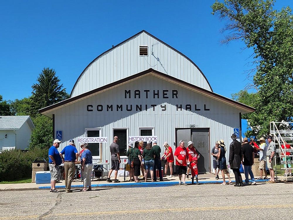 People gather outside Mather (Manitoba) Community Hall during a community event
